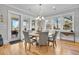 Open dining room with a round table, hardwood floors, and views of the outside at 1857 W Canning Dr, Mount Pleasant, SC 29466