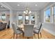 An open dining area with views to the outdoor patio and a stylish light fixture with seating for six at 1857 W Canning Dr, Mount Pleasant, SC 29466