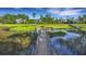 Picturesque long wooden dock leading into a marshy area with trees in the background at 1857 W Canning Dr, Mount Pleasant, SC 29466
