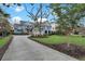 Charming two-story home featuring a two-car garage, inviting front porch, and beautiful blue siding at 1857 W Canning Dr, Mount Pleasant, SC 29466