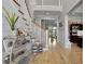 Bright foyer with hardwood floors, staircase, and decorative shelving, offering a glimpse into the living spaces at 1857 W Canning Dr, Mount Pleasant, SC 29466