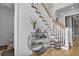 Elegant foyer featuring hardwood floors, a staircase with white railings, and stylish decorative elements at 1857 W Canning Dr, Mount Pleasant, SC 29466