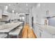 Modern kitchen with stainless steel appliances, large center island with barstool seating, and custom white cabinets at 1857 W Canning Dr, Mount Pleasant, SC 29466