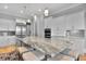 Open concept kitchen boasts a large island with marble countertop, seating, and modern pendant lighting at 1857 W Canning Dr, Mount Pleasant, SC 29466