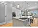 Bright and airy kitchen island with a stainless steel sink, marble countertop, and seating at 1857 W Canning Dr, Mount Pleasant, SC 29466