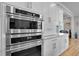 Close up of the stainless steel oven with built-in microwave and white cabinetry at 1857 W Canning Dr, Mount Pleasant, SC 29466