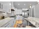Modern kitchen featuring stainless steel appliances, a large island with marble countertop, and white cabinetry at 1857 W Canning Dr, Mount Pleasant, SC 29466