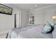 Spacious main bedroom featuring an ornate bed, neutral decor, and adjoining ensuite bathroom and walk-in closet at 1857 W Canning Dr, Mount Pleasant, SC 29466