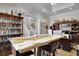 Spacious home office featuring a large wooden table, custom shelving, and elegant decor at 1857 W Canning Dr, Mount Pleasant, SC 29466