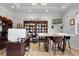Bright and airy home office featuring custom wooden shelving, a large table with chairs, and natural light at 1857 W Canning Dr, Mount Pleasant, SC 29466