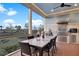 Covered patio features an outdoor dining table with backyard views and a full outdoor kitchen at 1857 W Canning Dr, Mount Pleasant, SC 29466
