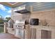 Covered outdoor kitchen features a grill, counter space, and stainless steel storage for outdoor cooking at 1857 W Canning Dr, Mount Pleasant, SC 29466
