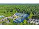 Aerial view showcases the community's pristine tennis courts surrounded by lush greenery and trees at 1857 W Canning Dr, Mount Pleasant, SC 29466