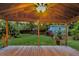 Covered patio in a lush backyard with a shed, string lights, and green grass at 188 Ponderosa Dr, Ladson, SC 29456
