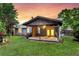 An open, covered wooden patio with decorative outdoor lighting is a backyard highlight at 188 Ponderosa Dr, Ladson, SC 29456