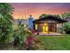 Backyard with covered deck, manicured lawn, and landscaped flower beds at 188 Ponderosa Dr, Ladson, SC 29456
