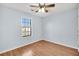 Bedroom with ceiling fan, a window, wood-look flooring, and light-blue painted walls at 188 Ponderosa Dr, Ladson, SC 29456