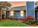 Outdoor view of blue siding and flower beds with beautiful flowers at 188 Ponderosa Dr, Ladson, SC 29456