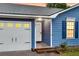 Close-up view of the blue home's entryway and garage, showcasing the charming details at 188 Ponderosa Dr, Ladson, SC 29456