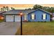 Charming blue home with a two-car garage and inviting curb appeal at twilight at 188 Ponderosa Dr, Ladson, SC 29456