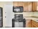 Kitchen with black microwave and oven, light cabinetry and wood-look floors at 188 Ponderosa Dr, Ladson, SC 29456
