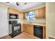 Kitchen featuring black appliances, light-colored cabinetry, and wood-look flooring at 188 Ponderosa Dr, Ladson, SC 29456