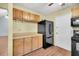 Kitchen with cabinets, countertop, black appliances, and wood-look flooring at 188 Ponderosa Dr, Ladson, SC 29456