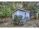 Charming backyard shed surrounded by lush roses in a landscaped yard at 188 Ponderosa Dr, Ladson, SC 29456
