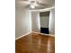 Minimalist bedroom with hardwood floors, ceiling fan, and a blue and grey accent curtain at 2000 Gray Battery Court Ct, Mount Pleasant, SC 29464