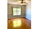 Cozy bedroom featuring hardwood floors, a ceiling fan, and a large window at 2000 Gray Battery Court Ct, Mount Pleasant, SC 29464