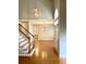 Welcoming home foyer featuring hardwood flooring, elegant light fixtures, staircase and dining area in the background at 2000 Gray Battery Court Ct, Mount Pleasant, SC 29464