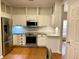 Contemporary kitchen features stainless steel appliances, white cabinetry with granite countertops, and hardwood floors at 2000 Gray Battery Court Ct, Mount Pleasant, SC 29464