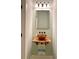 Charming powder room featuring rustic wooden vanity with copper bowl sink and sleek fixtures, illuminated by sconce lighting at 2000 Gray Battery Court Ct, Mount Pleasant, SC 29464