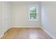 Bedroom with a clean, minimalist look featuring hardwood floors, a white door, and a bright window at 201 Driver Ave, Summerville, SC 29483
