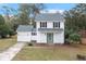 Charming two-story home with white siding, green door, and well-maintained yard at 201 Driver Ave, Summerville, SC 29483