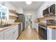 Galley kitchen featuring white cabinets, butcher block counters, and stainless steel appliances at 201 Driver Ave, Summerville, SC 29483
