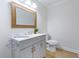 Clean powder room with white vanity, stylish mirror, and modern fixtures, offering a fresh and inviting space at 201 Driver Ave, Summerville, SC 29483