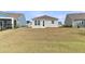 The backyard has a modest area of lawn with an exit/entrance door and two windows at 202 Garden Gate Way, Summerville, SC 29486