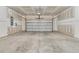 Spacious two-car garage with a metal door, ample unfinished wall and ceiling space, and concrete floor at 202 Garden Gate Way, Summerville, SC 29486