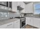 Bright kitchen features white cabinetry, stainless steel appliances, and light countertops at 202 Garden Gate Way, Summerville, SC 29486