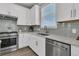 Bright kitchen features white cabinetry, stainless steel appliances, and light countertops at 202 Garden Gate Way, Summerville, SC 29486
