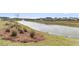 Community pond with a fountain feature, lush greenery, and views of well-maintained homes at 202 Garden Gate Way, Summerville, SC 29486