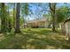 Well-maintained backyard featuring a lush lawn, mature trees, and a charming deck area for outdoor relaxation at 213 Travelers Rest Blvd, Summerville, SC 29485