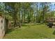 Spacious backyard with lush green grass and mature trees, providing ample space for outdoor activities at 213 Travelers Rest Blvd, Summerville, SC 29485
