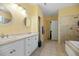 Bright bathroom featuring double sinks, a soaking tub, and tiled shower at 213 Travelers Rest Blvd, Summerville, SC 29485