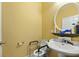 Well-lit bathroom features a pedestal sink, an oval mirror, and a comfort toilet at 213 Travelers Rest Blvd, Summerville, SC 29485