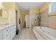 Bright bathroom featuring double sinks, a soaking tub, and tiled shower at 213 Travelers Rest Blvd, Summerville, SC 29485