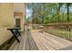 Wide wooden deck with a grill and table, overlooking a wooded yard at 213 Travelers Rest Blvd, Summerville, SC 29485