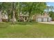 Inviting two-story home with a manicured lawn, mature trees, and a two car garage at 213 Travelers Rest Blvd, Summerville, SC 29485