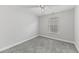 A well-lit bedroom has plush carpeting, a ceiling fan, and a large window at 215 Overcup Loop, Summerville, SC 29486